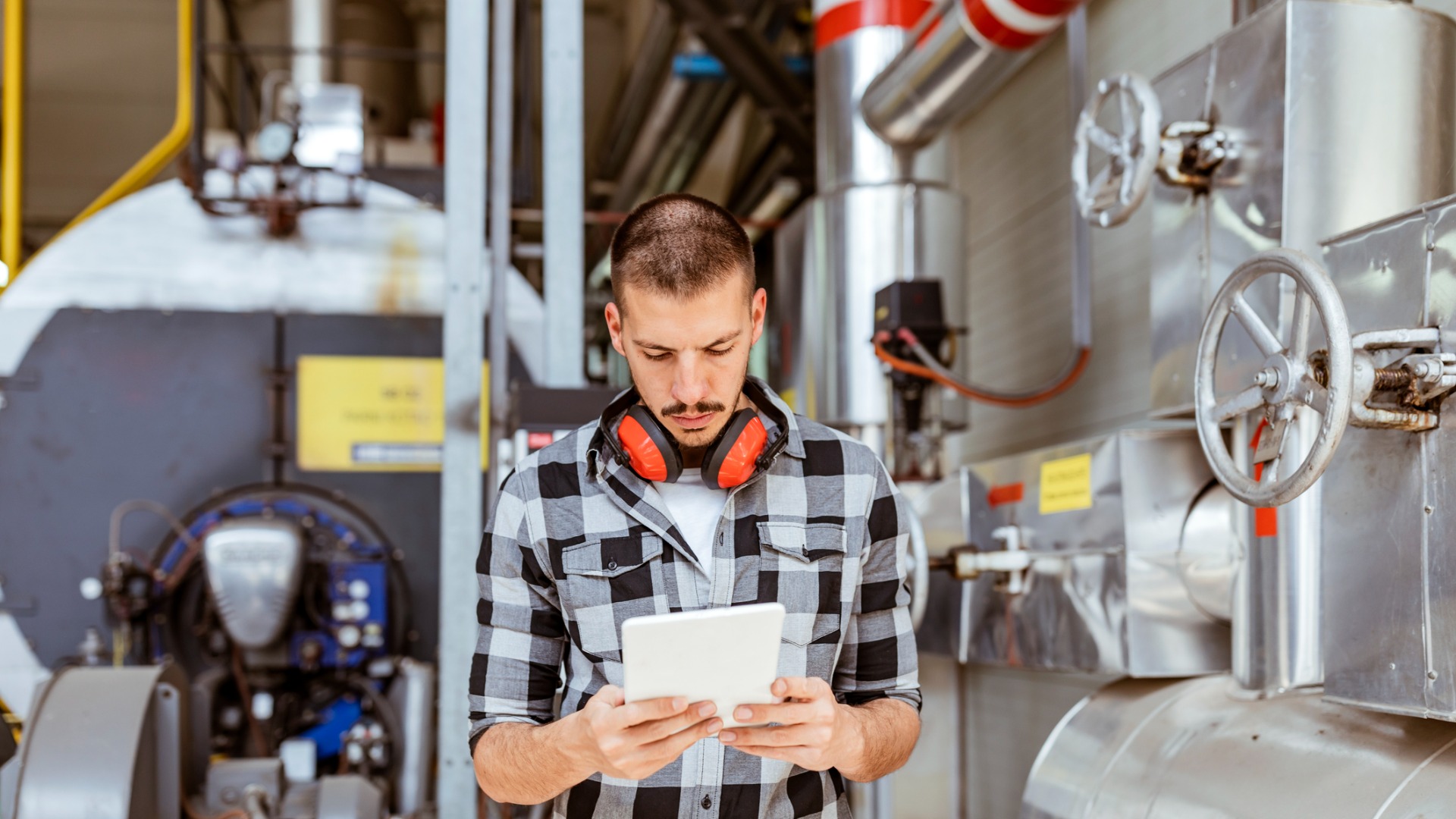 Young man checking gas compressor